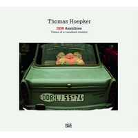 The book cover for Thomas Hoepker: DDR Ansichten, Views of a vanished country. The central photograph shows the rear of a pale green vintage Trabant car. Visible through the back window is a decorative heart-shaped pillow, pink and green with yellow and pink yarn flowers. The car has an East German license plate that reads DDR LJ 55-74. The publisher, Hatje Cantz, is credited at the bottom.