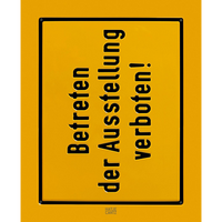 A bright yellow, square sign with a black border and embossed black text. The text is in German, arranged vertically, and reads Betreten der Ausstellung verboten!, which means Entering the exhibition is forbidden!. The sign is set against a black background.