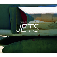 The cover for Jets by Thomas Florschuetz, featuring a close-up photograph of a military jet. The image shows the weathered, riveted fuselage in faded green and white, with a red detail on an air intake. Below the wing are two large, green external fuel tanks.