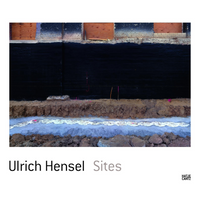 The book cover for Ulrich Hensel Sites, published by Hatje Cantz. The cover photograph shows a cross-section of an excavation site. The image is composed of horizontal layers: a brick wall with boarded-up windows at the top, a thick black section below it, followed by a layer of brown earth, a band of light blue and white material, and dark soil and rocks at the very bottom.