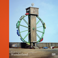 The book cover for Frank Kunert Wonderland, featuring a surreal photograph of a miniature model. A large green Ferris wheel with colorful vintage toy cars instead of cabins is mounted on a tall concrete tower. The tower houses a tavern, with a red car driving into the top floor. In the foreground, two toy cars are overturned on the pavement of a desolate lot under a clear blue sky.