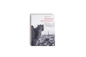 A book titled Städtebau des Erinnerns by Wolfgang Pehnt is centered on a white background. The cover features a black-and-white photograph of a stone gargoyle in the foreground, looking out over the cityscape of Paris with the Eiffel Tower visible in the distance. The title is printed in red.