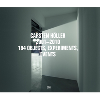 The cover of the book Carsten Höller 2001–2010, 184 Objects, Experiments, Events. The title is in a white sans-serif font over a photograph of a stark, modern interior with grey walls and a concrete floor, seen from the perspective of a darker hallway looking into a lit room. The publisher Hatje Cantz is credited at the bottom.