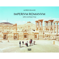 The cover of the book Imperivm Romanvm by Alfred Seiland, showing a photograph of ancient Roman ruins in a desert landscape under a pale blue sky. A small group of people stand on the sandy ground in the foreground, with extensive colonnades and hills visible in the background.