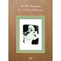 The cover of the book Annette Messager, Les Tortures Volontaires, published by Hatje Cantz. The cover has a brown, textured background with the title written in white cursive. Below the title is a mounted black-and-white photograph with a green border, showing a woman's face in profile, her features distorted by a paper and metal device.