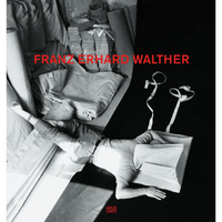 The cover for a book on Franz Erhard Walther, featuring a black-and-white photo of a person lying on the floor. Their head is inside a boxy, canvas art piece with two long white ribbons extending from it. The person is in a studio-like space filled with bolts and piles of fabric. The artist's name is overlaid in large, red capital letters.