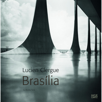 The book cover for Lucien Clergue Brasília, featuring a striking black and white photograph of modernist architecture. From a low angle, the image captures the monumental, curved concrete columns of a building. The elegant arches and a cloudy sky are perfectly reflected in the still water that fills the foreground. The book's title is overlaid on the reflection.