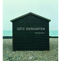 The cover of the photography book Götz Diergarten Photographs, featuring a dark green wooden hut on a pebble beach.