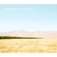 The cover of The Third Day by Henrik Spohler shows a golden field and a neat line of green trees in front of a mountain range under a pale blue sky.