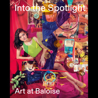 A book cover titled Into the Spotlight shows a colorful collage of a woman in a green top surrounded by photographs, perfume bottles, and various objects.