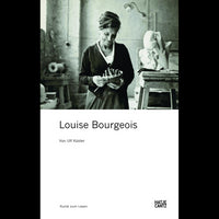 A black-and-white photograph on a book cover shows artist Louise Bourgeois in her studio, smiling as she holds a small sculpture.