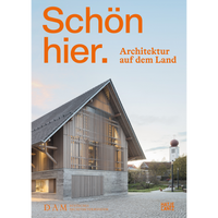 The cover of the German architecture book Schön hier. Architektur auf dem Land, featuring a modern timber and concrete building in a village square at dusk.
