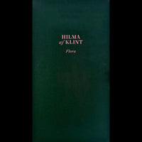 A dark green book cover with the title Flora by Hilma af Klint in pink lettering.