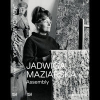 A black-and-white book cover for Jadwiga Maziarska Assembly, featuring a photograph of the artist in her studio next to a heavily textured painting, with a wooden sculpture in the background.