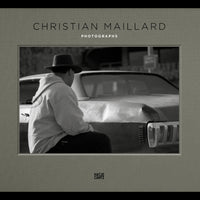 The cover of the book Christian Maillard Photographs, featuring a black-and-white photo of a person in a hat and hoodie sitting on the trunk of a car.