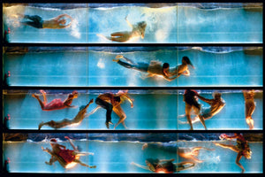 A composite photograph arranged in four stacked, horizontal panels, each showing a cross-section of a long, illuminated tank filled with blue water. Numerous people in everyday clothes are submerged, captured in dynamic and dramatic poses as they swim, float, and interact underwater, creating a surreal and dreamlike scene.