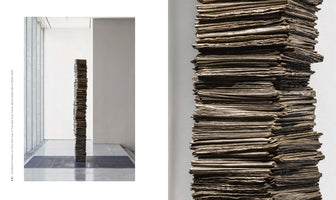 A diptych of a sculpture called Untitled (A Column of Time). The left image shows the full sculpture, a tall, slender column made of stacked newspapers, standing in a minimalist gallery. The right image is a close-up of the column, showing the weathered, uneven texture of the compressed layers of paper.