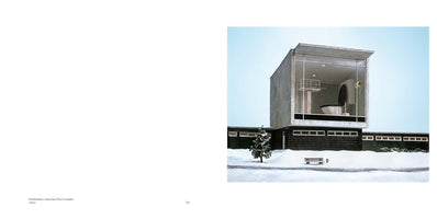 A photograph of a surreal architectural model in a snowy landscape, presented on the right-hand page of a book. A low, dark building is topped by a large, glass-walled concrete room containing a giant toilet with a diving board aimed at the bowl. A snow-dusted tree and a bench are in the foreground.