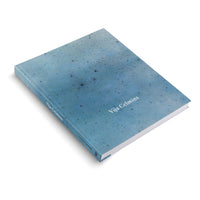 An angled view of a hardcover book titled Vija Celmins on a white background. The book has a textured, mottled blue cover that resembles a starry night sky, with the title in white text on the front and spine.
