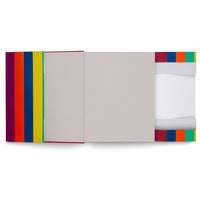 A top-down view of an open book or portfolio against a white background. The left cover displays vibrant vertical stripes of purple, red, orange, blue, yellow, and green. The interior is light gray, and the right side features a pocket with a similar multicolored striped design, containing a white sheet of paper.
