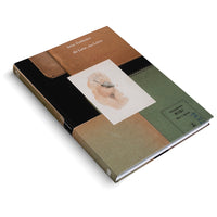 An angled, overhead shot of a hardcover book titled Irène Zurkinden, die Liebe, das Leben, on a white background. The cover is a collage of brown, black, and olive-green paper, resembling sketchbooks. Centered on the cover is a watercolor sketch of a hand holding a brush painting a nude torso.