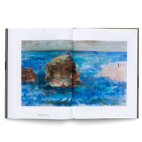 A high-angle shot of an open art book on a white background. The book displays a two-page spread of a colorful, expressive painting titled Böcklinade, 1958. The painting is a seascape with a turbulent, deep blue ocean and large brown rocks where numerous stylized pink figures are lounging and swimming. More figures are visible on a sandy beach in the distance.