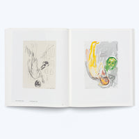 An open art book on a white background, viewed from above. The two-page spread displays two expressionist artworks. On the left is a black-and-white ink drawing of an abstract figure. On the right is a watercolor of an upside-down figure in yellow and orange, with a green face to its side against a grey background.